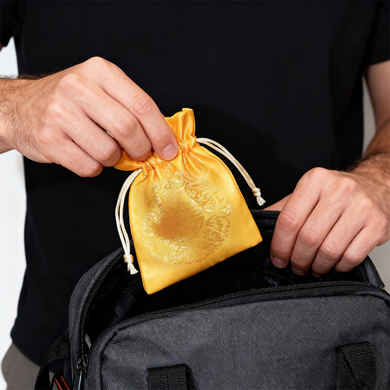 placing Career Success Talisman in a golden pouch into a backpack, carrying career luck and opportunities wherever he goes.