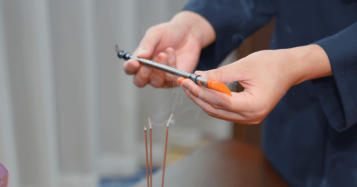 Taoist master grasping ritual brush, focused energy for sacred talisman creation