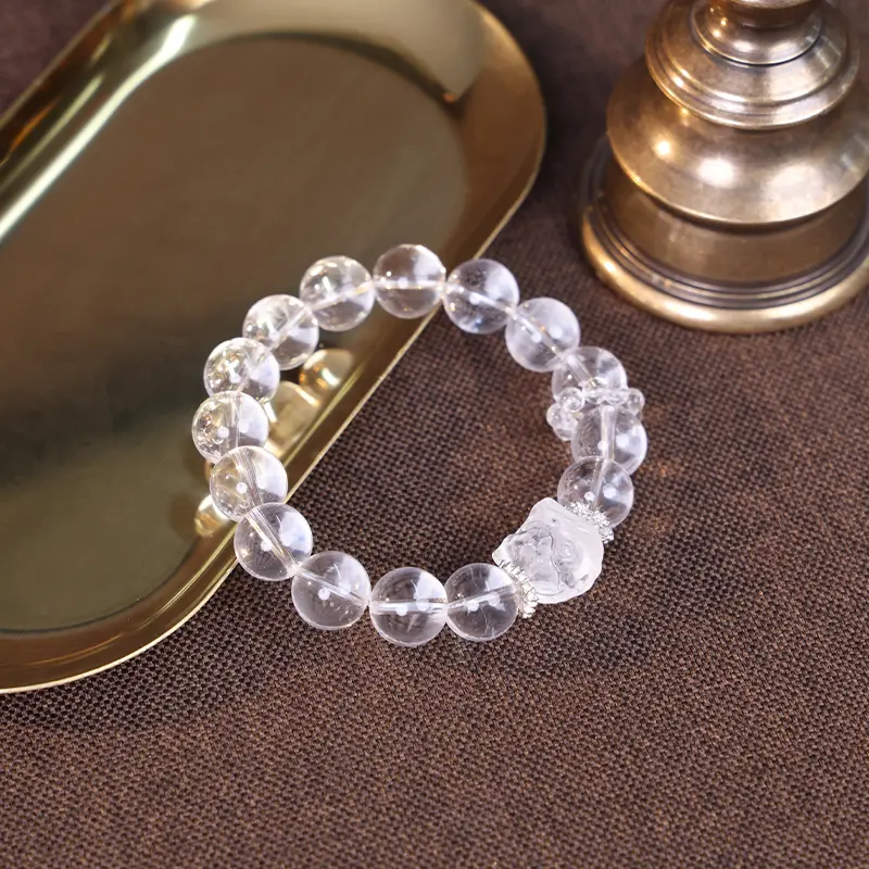 Clear Quartz bracelet for better balance displayed with golden props.