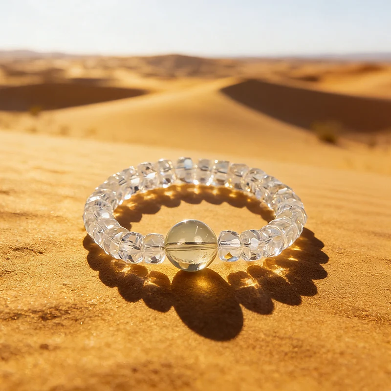 Natural citrine bead bracelet resting on golden desert sand.