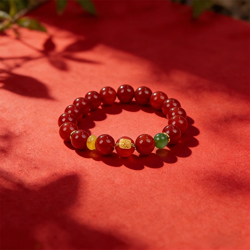 Natural red agate bracelet styled with leaf shadows for fire energy.