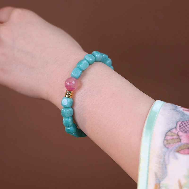 Close up of a green amazonite bracelet worn on the wrist.