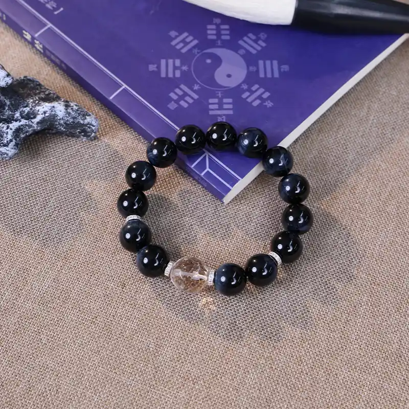 Hawk's eye bracelet styled with the Taoist classic I Ching for mental clarity.