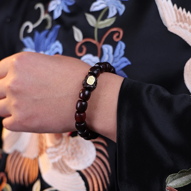 Man wearing a protection beads bracelet for grounding and stability.