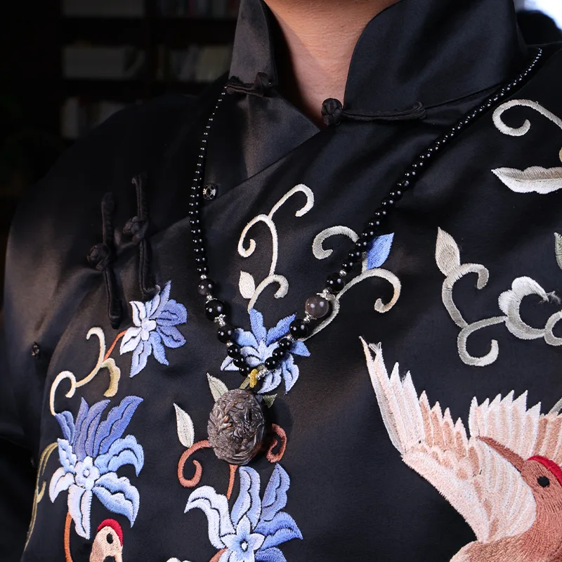 Man wearing a silver obsidian necklace for spiritual protection.