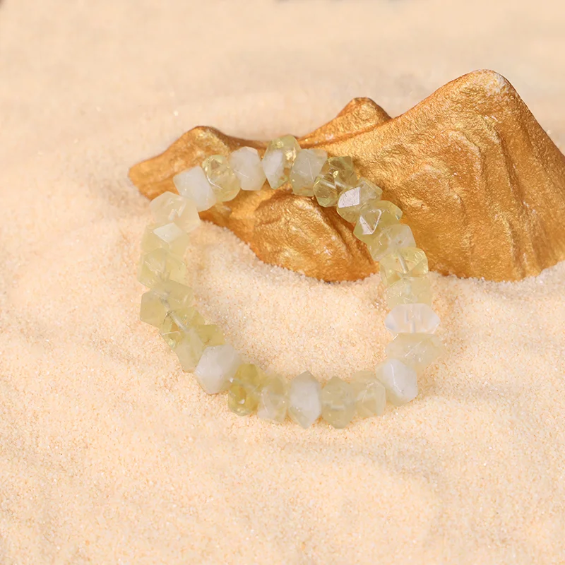 Natural citrine bracelet for prosperity styled on a sandy background.