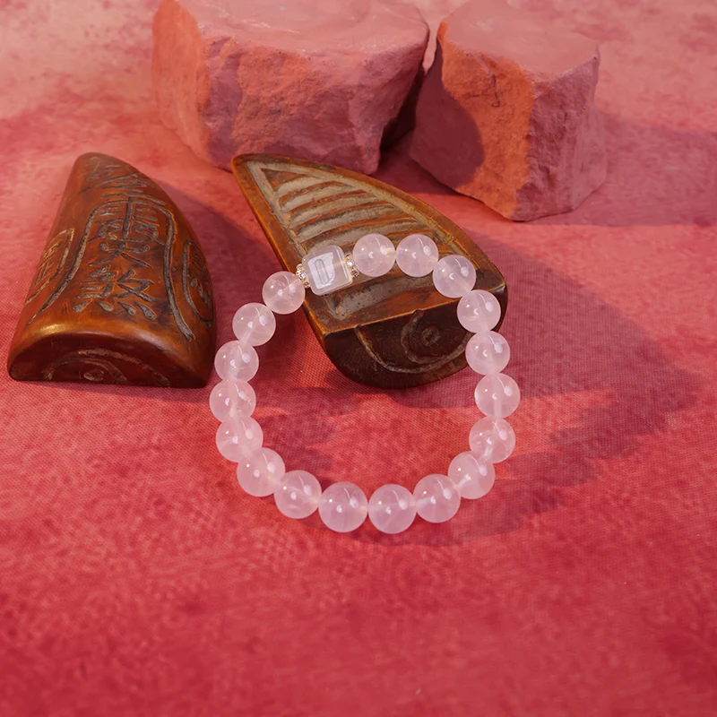 Rose quartz bead bracelet representing fire element and harmony.