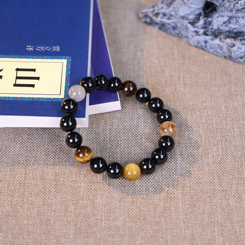 Tiger eye bead bracelet styled with the I Ching for confidence and wisdom.