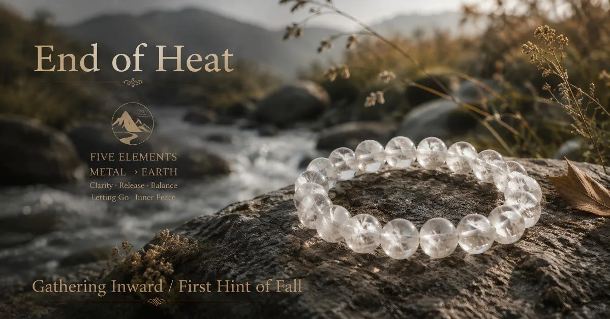 End of Heat solar term clear quartz bracelet on river rock with flowing stream and autumn landscape — five elements Metal to Earth transition, clarity release balance letting go inner peace — TaoAura gathering inward first hint of fall